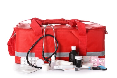 Rote Arzttasche aus Kunststoff vor weißem Hintergrund